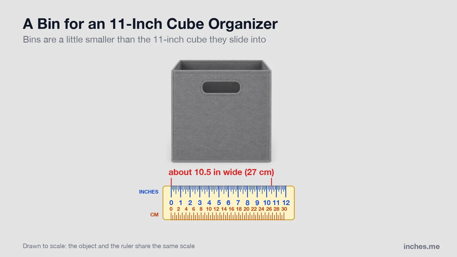 Gray fabric storage bin with a handle cutout above a ruler, about 10.5 inches wide